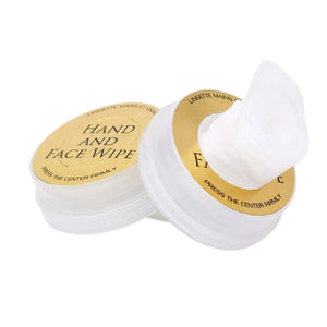 Two white hand and face wipes with gold labels on a white background
