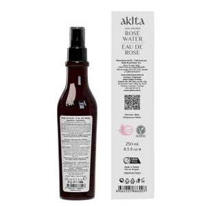 Brown spray bottle and white box of akita Rose Water on a white background