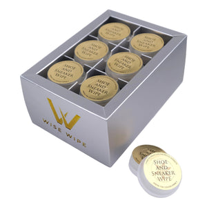 Box of Wise Wipe shoe and sneaker wipes with a single wipe on a light gray background