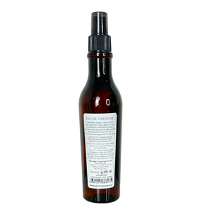 Dark brown cologne bottle with a label on a white background