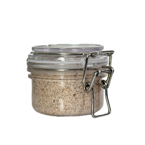 Small glass jar with metal clasp on a white background