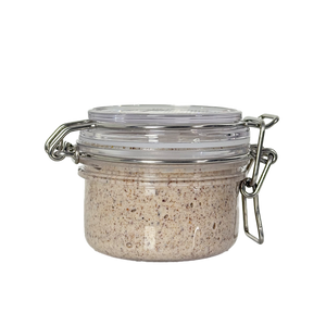 Small glass jar with metal clasp on a white background