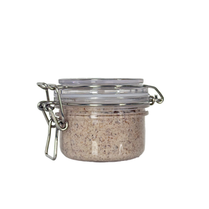 Glass jar with metal clasp on a white background