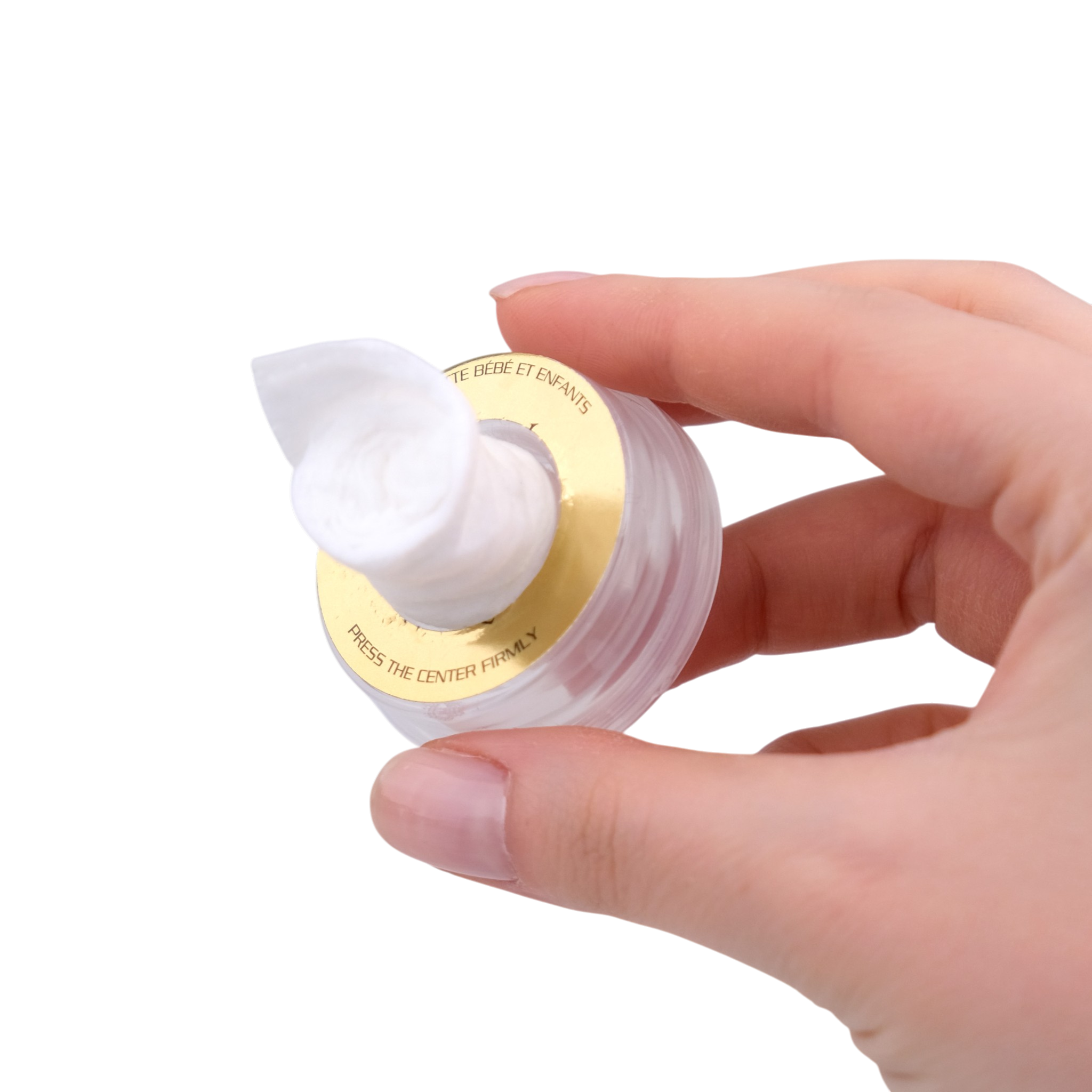 Hand holding a small container of cream with a white lid on a white background