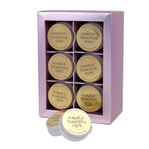 Set of makeup remover wipes in a pink box on a white background