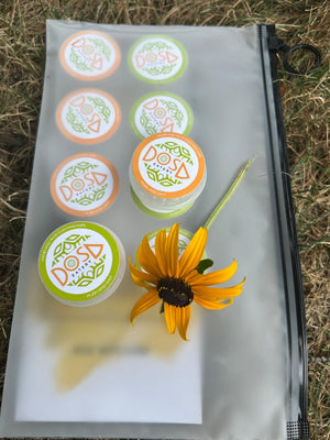 Set of decorative stamps on a clear block with a yellow flower on a grassy background