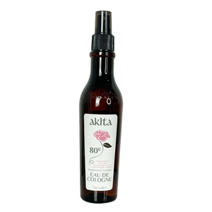 Bottle of Akita cologne with a rose on the label against a white background