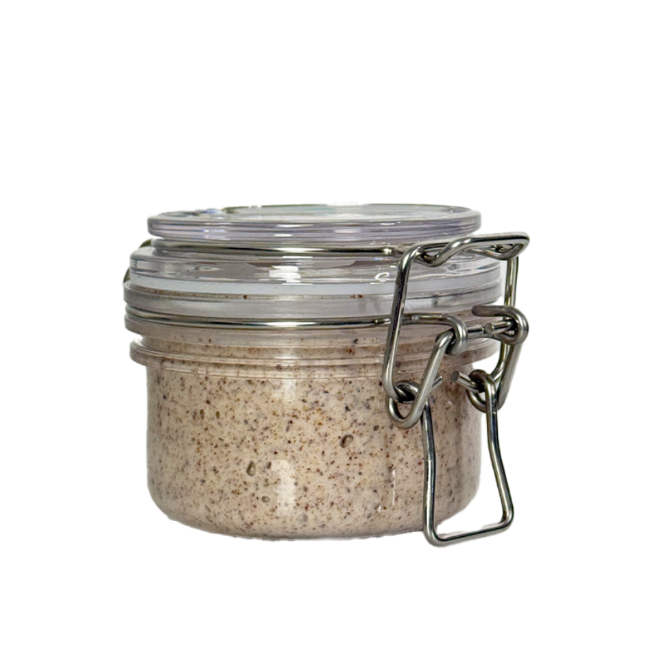 Small glass jar with metal clasp on a white background