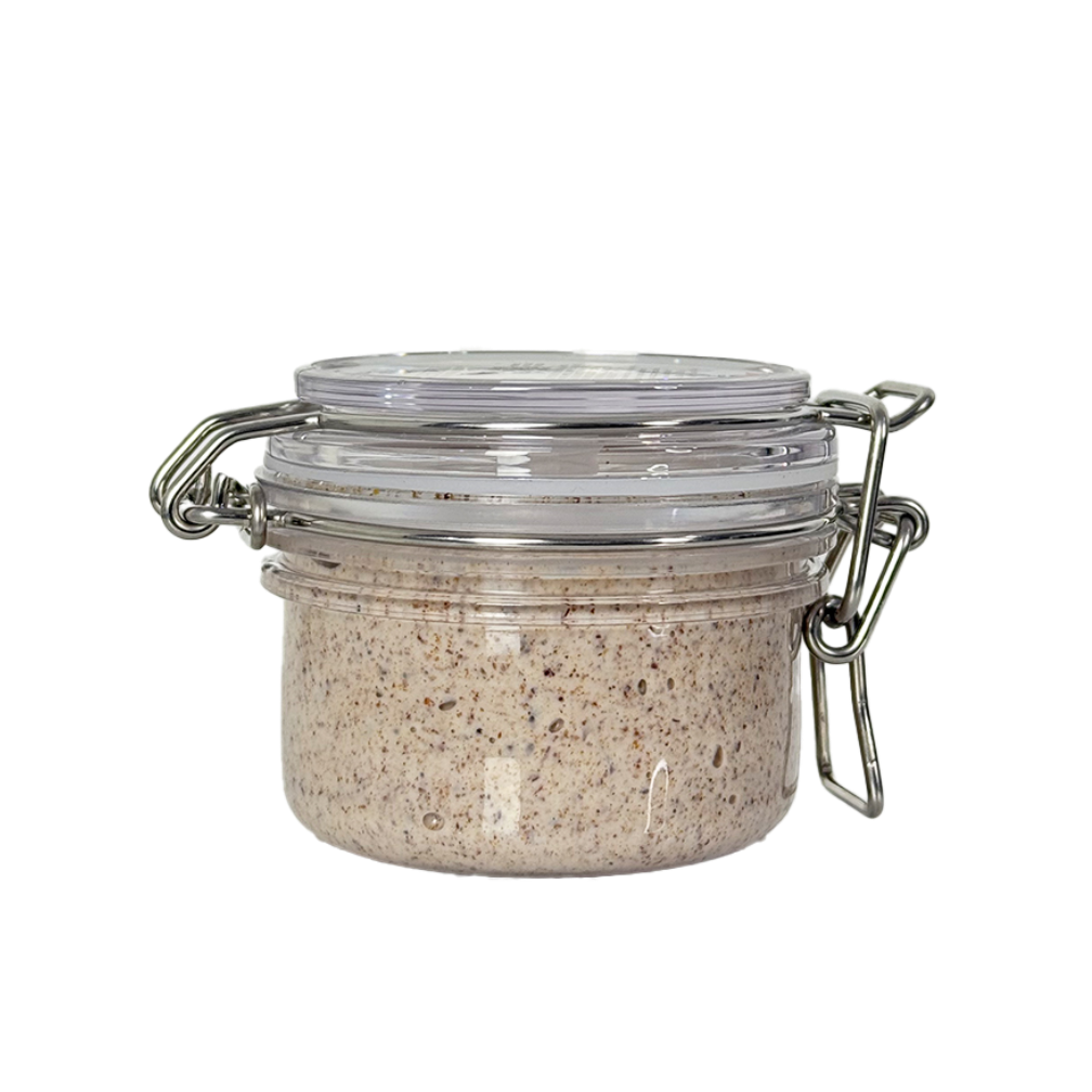 Small glass jar with metal clasp on a white background