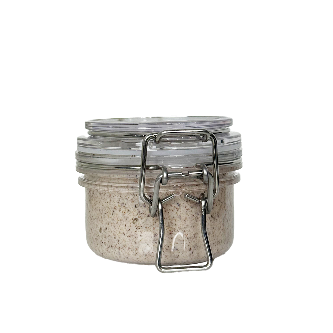 Glass jar with metal clasp on a white background