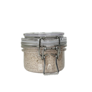 Glass jar with metal clasp on a white background