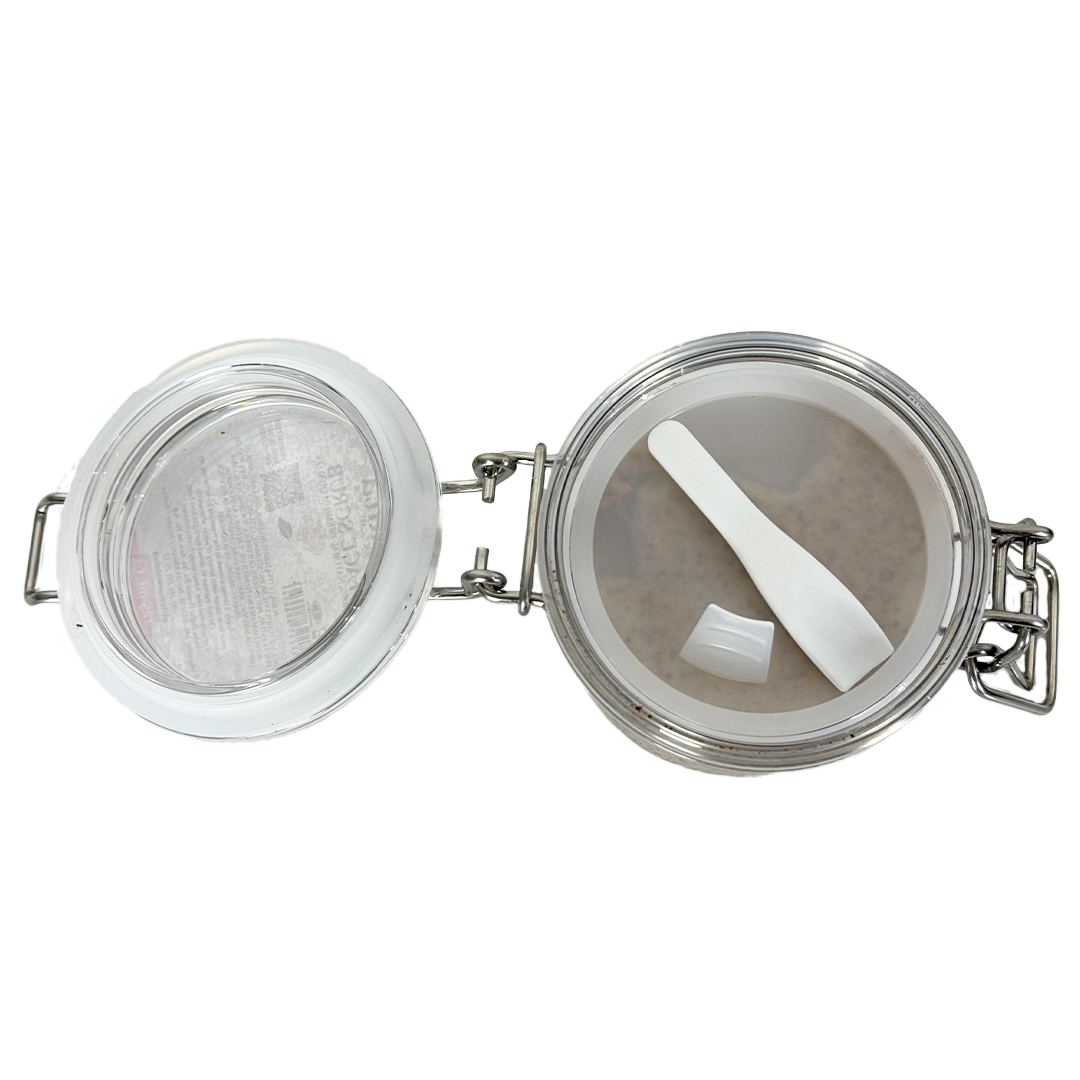 Tea infuser with mesh basket and white spoon on a white background