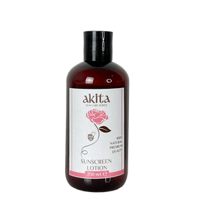 Bottle of Akita sunscreen lotion with a rose design on the label against a white background