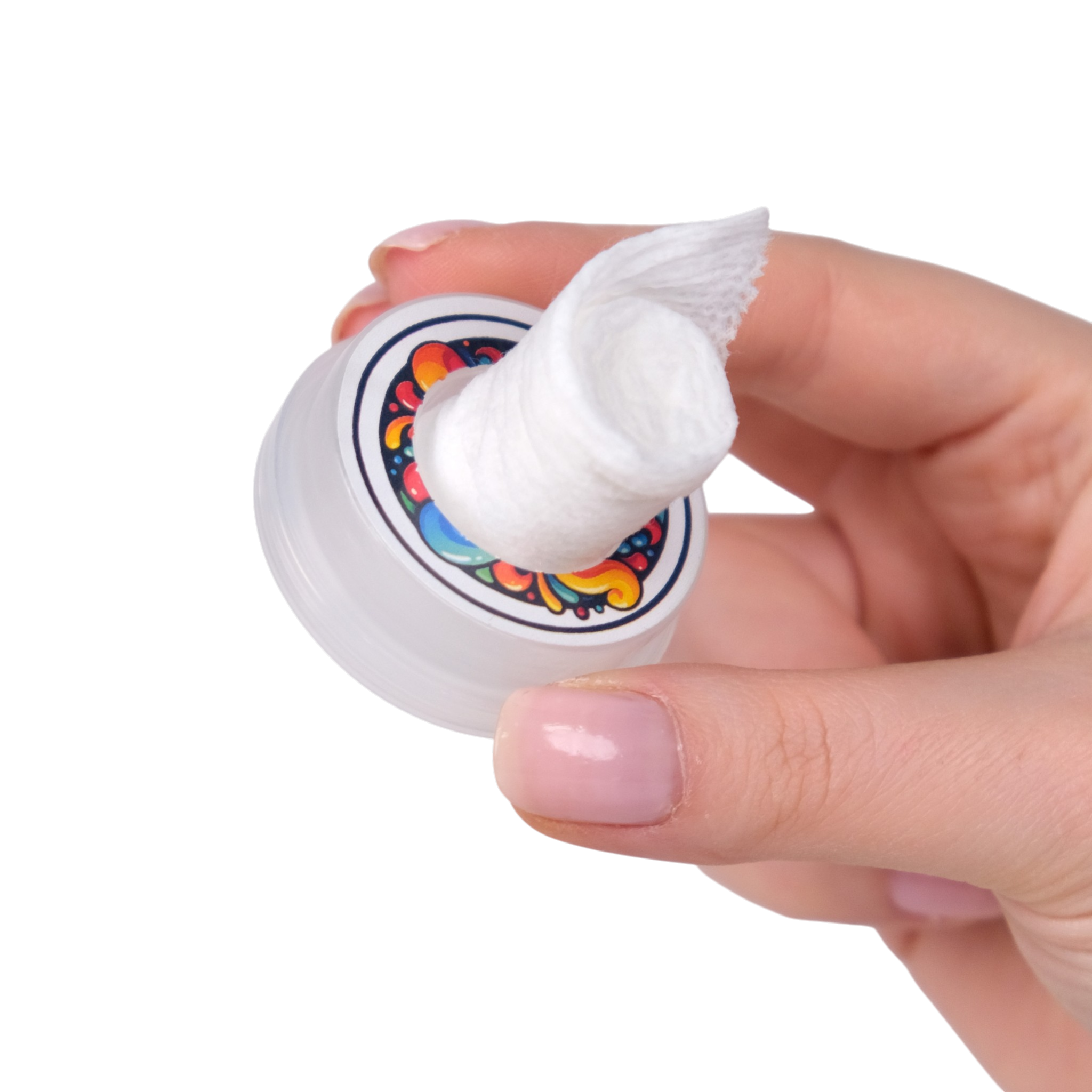Hand holding a small container of cream with a colorful label on a white background