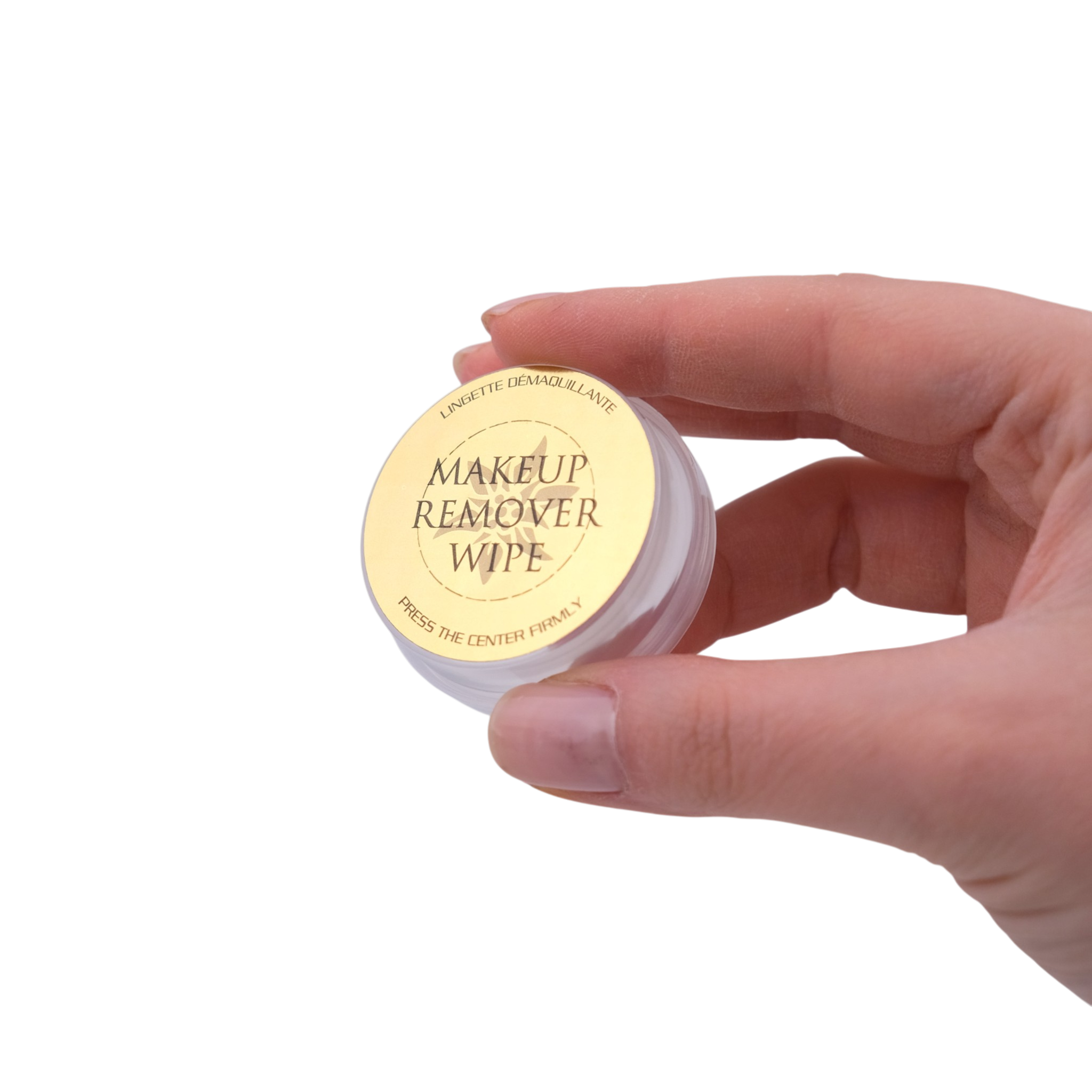 Hand holding a small container of makeup remover wipes on a white background