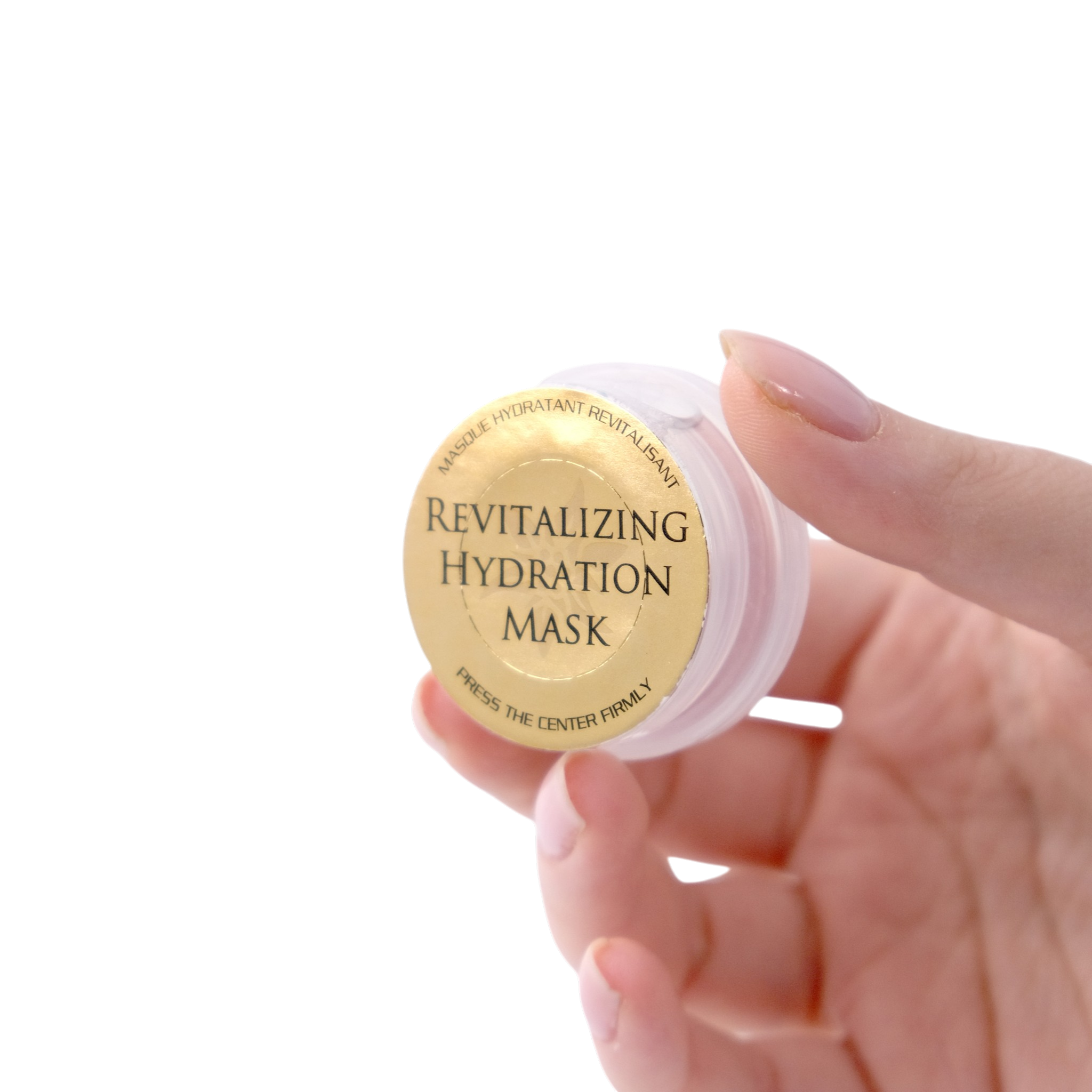 Hand holding a revitalizing hydration mask container with a gold label on a white background