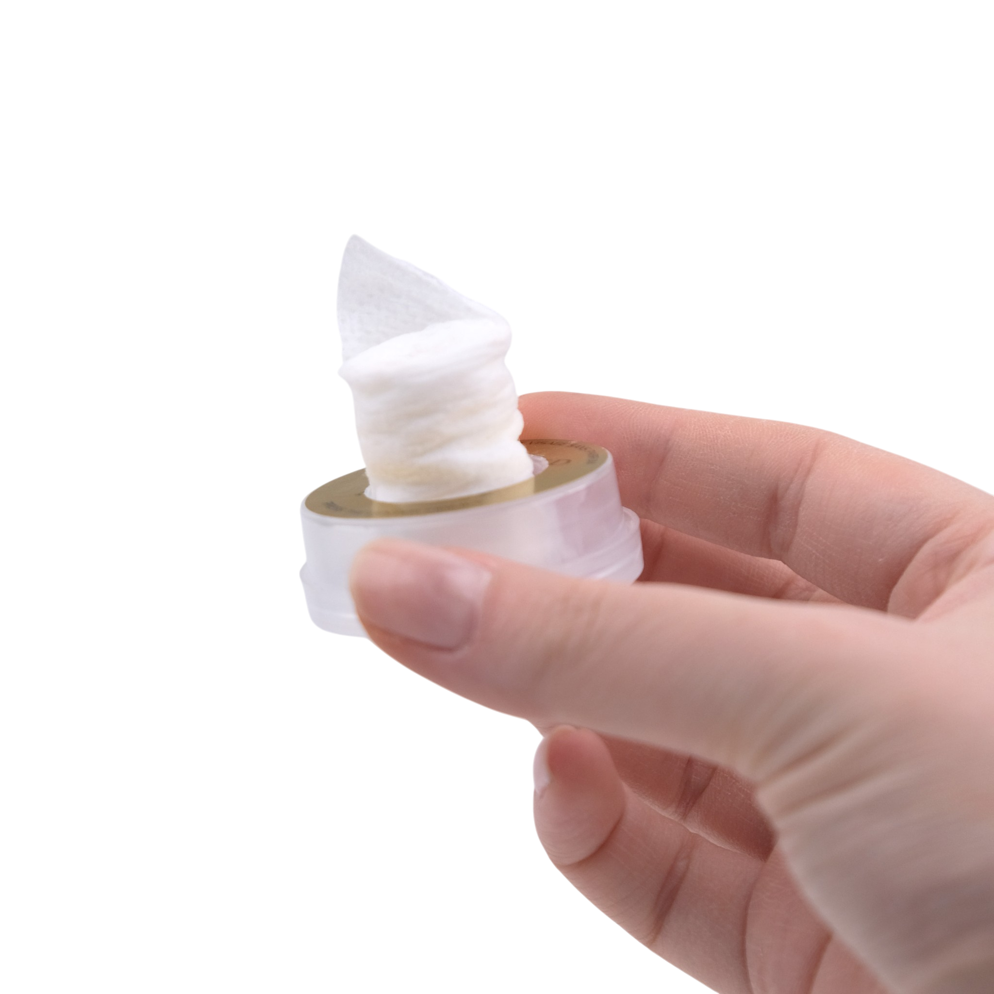 Hand holding a small container of white cream against a white background